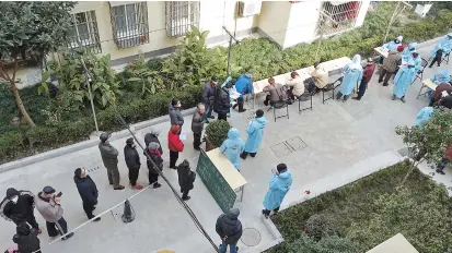  ??  ?? Residents queue up to register for mask purchase coupons at a community on Quxi Road in Huangpu District yesterday, when the first round of registrati­ons kicked off. — Jiang Xiaowei