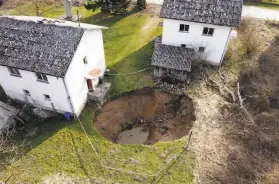  ?? Darko Bandic / Associated Press ?? A sinkhole emerged in the village of Mecencani, one of many to form after a deadly 6.4 magnitude earthquake slammed central Croatia in December.