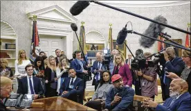  ?? GABRIELLA DEMCZUK / THE NEW YORK TIMES ?? Kanye West (in hat) and pro football legend Jim Brown (right) meet with President Donald Trump (left) in the Oval Office on Oct. 11.