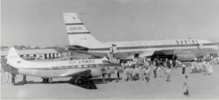  ?? Photo: Fiji Museum ?? Fiji Airways VQ FAL Heron in front of the QANTAS delivery of their first B707 138, VH EBB on July 2, 1959.