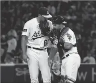  ?? Bay Area News Group/tns ?? Pitcher Lou Trivino of the Oakland Athletics talks with Catcher Josh Phegley in the 9th inning during the game between Seattle Mariners and Oakland Athletics at Tokyo Dome on March 20.