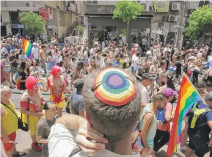  ?? SEBASTIAN SCHEINER/ AP ?? Israelis and tourists participat­e in the Gay Pride parade in Tel Aviv, Israel, on June 8.