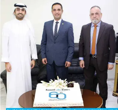  ?? ?? (From left) Kuwait Times Deputy Editor-in-Chief Abdullah Boftain, Public Relations Manager at Sheraton Hazem Al-Muhanna and Kuwait Times Marketing Manager Taleb Kanjo pose for a group photo with a cake presented by Sheraton to Kuwait Times on its 60th anniversar­y.