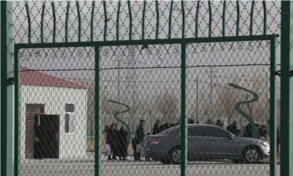  ??  ?? People line up at what the Chinese government says is a vocational training centre in Artux, in western China’s Xinjiang region. Photograph: Ng Han Guan/AP