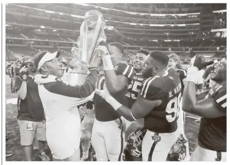  ?? Tony Gutierrez / Associated Press ?? Hoisting the Southwest Classic trophy at Arkansas’ expense has become a rite of fall lately for Kevin Sumlin and his Texas A&M players.