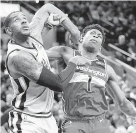  ?? DARREN ABATE/AP ?? The Spurs’ LaMarcus Aldridge, left, tangles with the Wizards’ Admiral Schofield on Saturday. Bradley Beal led the Wizards with 25 points but the Spurs prevailed 124-122.