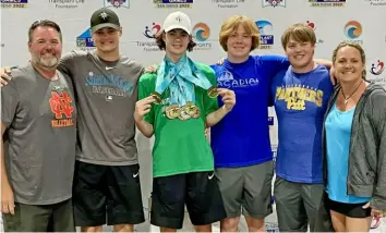  ?? Courtesy of Stacie Ball ?? Heart transplant recipient Luke Ball, 18, of Cranberry, wears the medals earned at this summer’s Transplant Games of America alongside, from left, his father, John; brothers Josh, Nate and Luke; and his mother, Stacie.