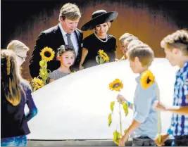  ?? Remko de Waal ?? The Associated Press Dutch King Willem-alexander, center left, and Queen Maxima, during the revealing Monday of the National Monument for MH17 victims in Vijfhuizen, The Netherland­s.