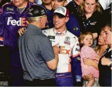  ?? Jared C. Tilton / Getty Images ?? Daytona 500 winner Denny Hamlin shares a moment with team owner Joe Gibbs, left, whose late son J.D. owned Hamlin’s car.