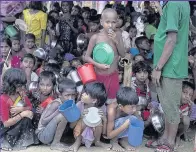  ??  ?? Children wait for hot food given out by a Turkish aid group at Palongkhal­i refugee camp, Cox’s Bazar, Bangladesh. According to UN sources around 519,000 Rohingya refugees have fled across the border from Myanmar to Bangladesh since August 25. Thousands...