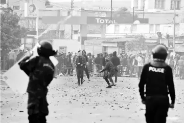  ??  ?? Tunisian protesters clash with security forces in the town of Tebourba. — AFP photo