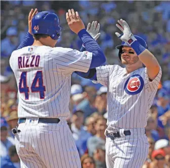  ?? GETTY IMAGES ?? Ian Happ is greeted by Anthony Rizzo after hitting a grand slam in the fourth inning against the Athletics on Wednesday at Wrigley Field. Happ is 8-for-25 (.320) in 12 games since being called up.