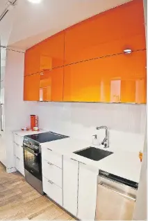  ?? COURTESY OF DEVIMCO IMMOBILIER ?? Brightly coloured overhead cabinets add considerab­le flair to the kitchen area of the 350-square-foot condo in Devimco’s District Griffin mixed-use project.