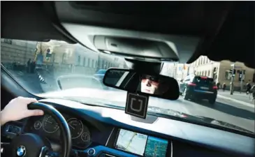  ?? LAETITIA VANCON/THE NEW YORK TIMES ?? An Uber driver navigates through Munich, December 22, 2015.