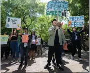  ?? PAUL KITAGAKI JR. — THE SACRAMENTO BEE ?? Students from Tuition Takeover raise signs that say “freeze the fees” during a protest at Sacramento State on Wednesday. They oppose the California State University system's 34% tuition hike over five years.