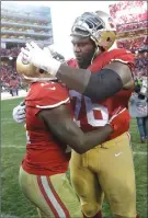  ?? Associated Press ?? San Francisco 49ers offensive tackle Anthony Davis, right, shocked the team by announcing his retirement at the age of 25 on Friday.