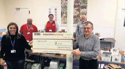  ??  ?? Great help Pictured from left are Care and Share’s Lizzie Adrian and Ayrshire Housing’s Jim Whiston, back left to right, Mark Maxwell, Karen Alexander and Ian Gall