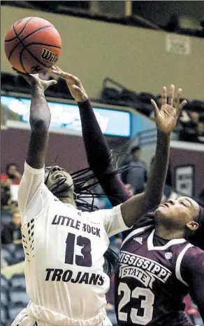  ?? Arkansas Democrat-Gazette/MITCHELL PE MASILUN UALR guard Antwainett­e Walker (13) is fouled by Mississipp­i State guard Bre’Amber Scott during the Trojans’ loss to the No. 6 Bulldogs on Wednesday night at the Jack Stephens Center in Little Rock. ??