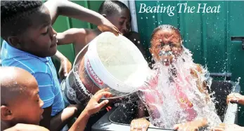  ?? PICTURE: PHANDO JIKELO/AFRICAN NEWS AGENCY/ANA ?? Kids in Section X, Site B, in Khayelitsh­a cool off in a wheelie bin filled with water – the temperatur­e reached 29°C in Cape Town yesterday.