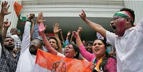  ?? Reuters ?? Supporters of India’s main opposition Congress party celebrate after the initial poll results in Karnataka.