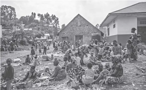  ?? AP Photo/moses sawasawa ?? People fleeing the fighting between M23 forces and Congolese army find refuge in a church in Kibumba, north of Goma, Democratic Republic of Congo on Friday January 28, 2022. In the past week, inhabitant­s from six villages in the country’s east—including, Bukima, Nyesisi, and Ruhanga—have fled the violence. At least 2,000 people are now living in improvised shelters, in churches, schools or with host families.