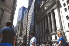  ?? AP PHOTO/SETH WENIG ?? People walk around the front of the New York Stock Exchange on June 2 in New York.