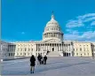  ?? DANIEL SLIM / GETTY IMAGES ?? People pause for pictures in front of the Capitol building in Washington DC on Tuesday.