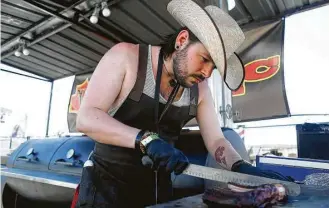  ?? Mark Mulligan photos / Houston Chronicle ?? Briton John Beard, of Red’s True Barbecue, competed in the Houston rodeo’s 2016 World’s Championsh­ip Bar-B-Que Contest.