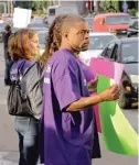  ?? TIM BOYLE/ FOR THE SUN- TIMES ?? Protesters including Anthony Lesure ( right) gather outside the Crowne Plaza Hotel in Rosemont on Monday.