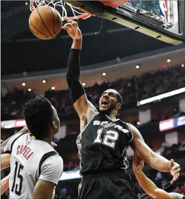  ?? ERIC CHRISTIAN SMITH / AP ?? Spurs forward LaMarcus Aldridge dunks for two of his season-high 34 points in Thursday’s Game 6 win at Houston. Aldridge also added 12 rebounds as he carried the Spurs with the absence of Kawhi Leonard.