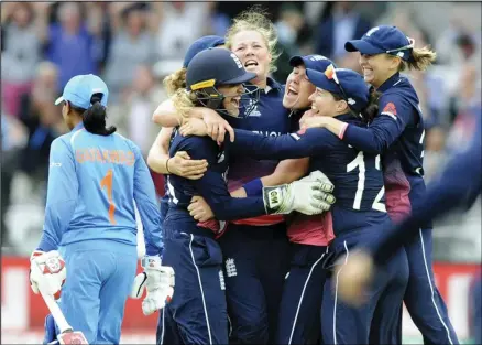  ??  ?? In this July 23, 2017 file photo, England’s Anya Shrubsole, centre, celebrates with teammates as England win the ICC Women’s World Cup 2017 final
match against India at Lord’s in London, England. (AP)