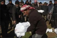  ?? GHAITH ALSAYED — THE ASSOCIATED PRESS ?? Mourners bury family members who died in a devastatin­g earthquake that rocked Syria and Turkey at a cemetery in the town of Jinderis, Aleppo province, Syria, Tuesday.