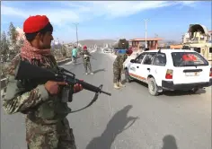  ??  ?? Afghan security personnel search passengers in a checkpoint on Highway One in — AFP photos