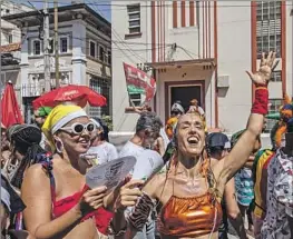  ?? Maria Magdalena Arréllaga Bloomberg ?? PARTYGOERS WEAR costumes at a street celebratio­n Friday in Rio de Janeiro, where officials expect about $1 billion in revenue at bars, hotels and restaurant­s.