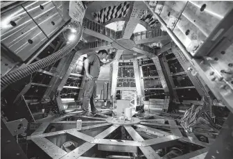  ?? Melissa Phillip / Staff file photo ?? Scientist Jim Rice works on the Orion spacecraft’s launch abort system last year. NASA is set to launch a test version of the spacecraft Tuesday to ensure astronauts could escape in a rocket failure.