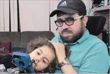  ?? JACQUES BOISSINOT THE CANADIAN PRESS ?? Aymen Derbali, seen with his daughter Maryem, was shot seven times in the Quebec City mosque shooting and paralyzed from the waist down.