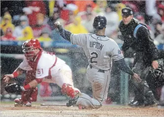  ?? ORLANDO SENTINEL FILE PHOTO ?? Tampa Bay Rays B.J. Upton scores on a Carlos Pena single to left centre against the Philadelph­ia Phillies in October 2008. Groundskee­pers watching this game wanted to know how it could withstand so much rain.