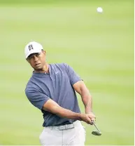  ?? RICHARD HEATHCOTE / GETTY IMAGES ?? Tiger Woods in action during a practice round for The Players Championsh­ip on The Stadium Course at TPC Sawgrass on Tuesday in Ponte Vedra Beach, Fla.