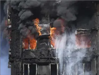  ?? VICTORIA JONES, THE CANADIAN PRESS ?? Smoke billows from a fire that has engulfed the 24-storey Grenfell Tower in west London, Wednesday.