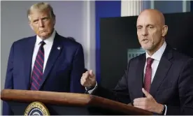  ??  ?? Donald Trump listens as Dr Stephen Hahn, commission­er of the FDA, speaks during a media briefing in the White House on 23 August. Photograph: Alex Brandon/AP