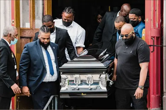  ?? Gabriela Bhaskar / New York Times ?? The coffin bearing the remains of Heyward Patterson, who was killed on May 14 in the racist shooting at a Tops Friendly Market, is carried from the Lincoln Memorial United Methodist Church in Buffalo on Friday. Patterson, a 67-year-old church deacon, was the first of 10 massacre victims to be laid to rest on Friday.