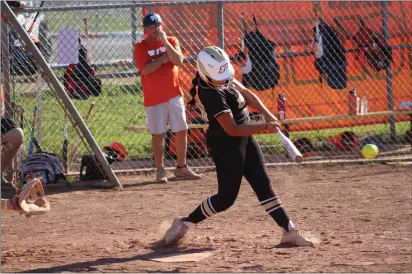  ?? PHOTOS BY SHAUN HOLKKO — DAILY DEMOCRAT ?? Pioneer sophomore third baseman Sofia Hernandez swings and hits an RBI double to deep center field during a 10-0 win at Woodland on Wednesday in Woodland.