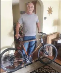  ?? PEG DEGRASSA - MEDIANEWS GROUP ?? Joe LaVallee stands proudly beside the very first wooden bicycle that he built by hand. Now with five wooden bikes to his credit, the Essington resident eagerly accepts custom orders for the hand-crafted bicycles.