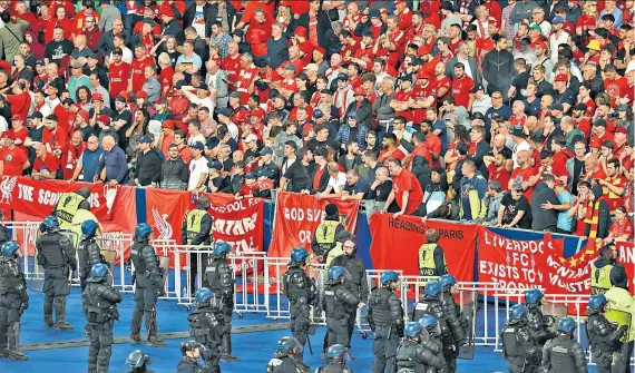  ?? ?? Traumatic: Police line up in front of Liverpool fans in the Stade de France last month