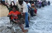  ?? — AFP ?? Physically challenged people enjoy during an event organised two days after the Internatio­nal Day of Persons with Disabiliti­es at the Elliots beach in Chennai on Sunday.