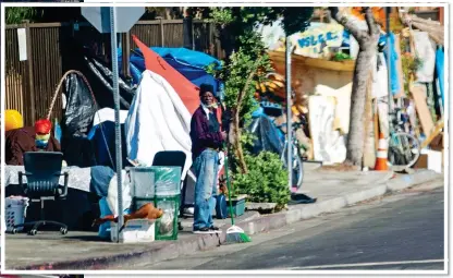  ??  ?? SQUALOR: Makeshift tents line the popular tourist destinatio­n of Venice Beach, left. Above: One of the city’s homeless – there are more than 66,000 people sleeping rough every night