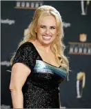  ??  ?? Rebel Wilson on the red carpet during the NFL Honors football awards show in Los Angeles on Feb. 2. Wilson returns to her roots as host of ABC’s “Pooch Perfect,” an eight-episode series featuring 10dog groomers and their assistants competing in challenges.