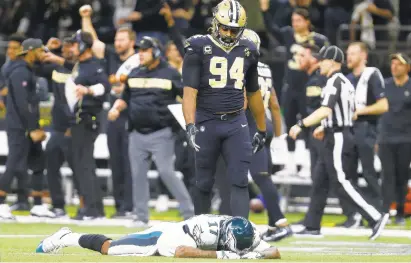  ?? BUTCH DILL/ASSOCIATED PRESS ?? Cameron Jordan (94) sees Alshon Jeffery react after a pass went through his hands to Marcus Lattimore for the Saints’ clinching intercepti­on.