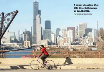  ?? PAT NABONG/SUN-TIMES ?? A person bikes along West 18th Street in Chinatown on Dec. 10, 2020.