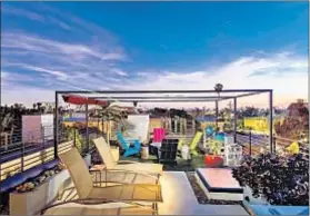  ??  ?? THE ROOFTOP deck, which offers 360-degree views, is set up for entertaini­ng with a built-in barbecue and bench seating.